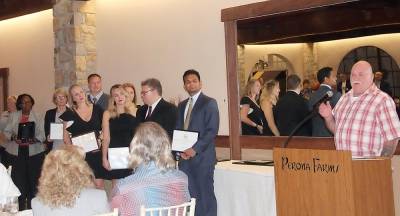 Lee Madsen (right) speaks at the Heart &amp; Soul celebration. In the group on the left are a representative from the Sparta EMS squad, Mary Hookway, Newton Medical Center’s emergency department providers, and the cardiac cath lab team that performed his stent surgery in the Charles L. Tice Heart Center. (Photo provided)