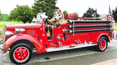 Sparky sits inside a 1938 Sanford Fire Truck.