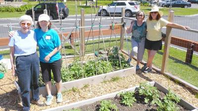 Volunteers Mary Spector, Marie Wilson, Claudia Kunath and Anita Schweizer are among the many seasoned gardeners who design and maintain the community gardens at Project Self-Sufficiency.