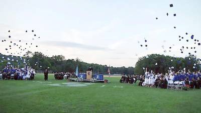 The traditional cap toss at the conclusion of a past Sparta graduation ceremony on the field (File photo by George Leroy Hunter)