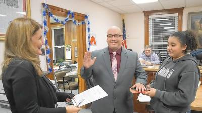 From left, Borough Clerk Robin Hough administers the Oath of Office to Councilman John Cruz, with Aryanna Cruz on right.