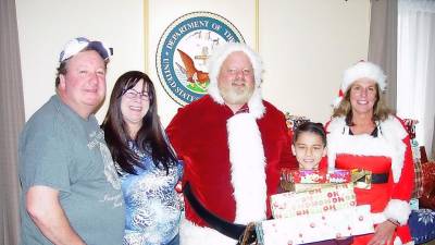 Santa Collins with Andy Lagana, Jamie Novoshelski, happy gift recipient Jakob Velasco and Loraine Collins