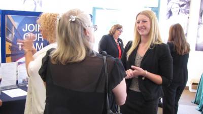 Kyersten Geiger of Project Self-Sufficiency speaks with a job seeker at a recent Project Self-Sufficiency Career Fair.