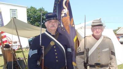 Union soldier re-enactor Jeff Chandler of the 27th NJ Regiment and Confederate soldier Ken Le Soine of the 23rd North Carolina Regiment pose with full military garb