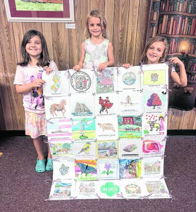 Girl Scouts from Troop 98765 in Ogdensburg pose with the quilt created by 7 different troops in the Wallkill Valley area.
