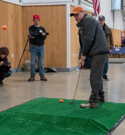 Blake Ellman takes part in the putting contest.