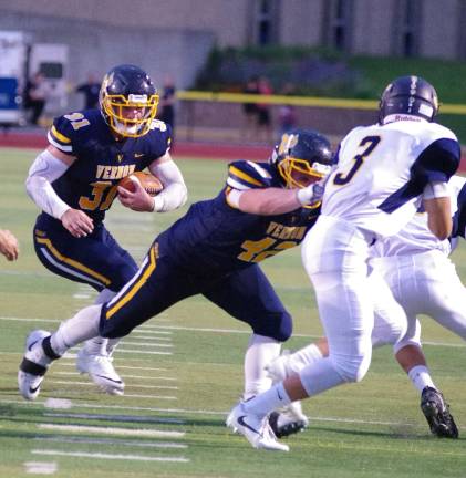 Vernon ball carrier Mike Stefkovich looks for an opening to run through.