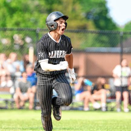 CJ Collins shouts his excitement while on his way to first base after collecting a hit against Pequannock.