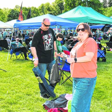 <b>Alicia, Scott and Declan Handel of Hewitt set up their chairs.</b>