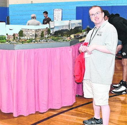 Jonathan Moor of Wantage poses in front of a train display.