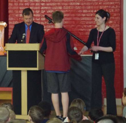 Standing behind the podium, Hamburg School&#xfe;&#xc4;&#xf4;s Chief School Administrator Roger Jinks, Jr. called students to the front of the room and recognized them for being named in their classes respective honor rolls.