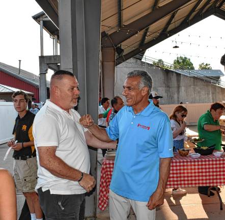 <b>Jack Ciattarelli, right, greets a supporter at the Election Kickoff Rally on Saturday, Aug. 16 at Skylands Stadium.</b>
