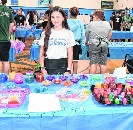 Samantha Perna poses at the Perna's Epoxy table.