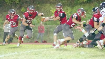 High Point running back Travis Tallamy is about to grab the ball from quarterback Alex Buchwald during a hand-off play early in the game. Tallamy rushed for 102 yards resulting in two touchdowns. Buchwald scored a running touchdown and threw a touchdown pass