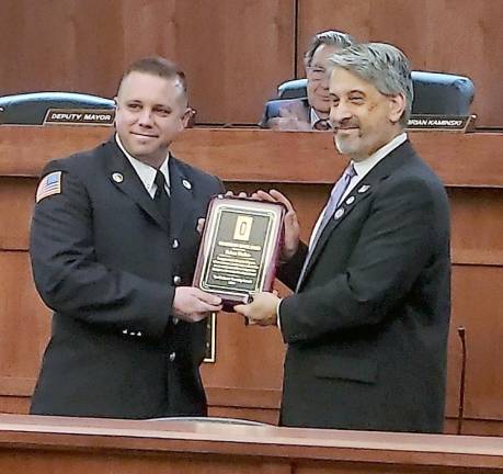 Robert Washer is presented with a 10-year service award for being part of the Hardyston Fire Department.