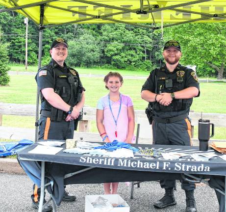 Sheriff's deputies Dominic Solimando and Anthony Reed pose with Brenna Maat.