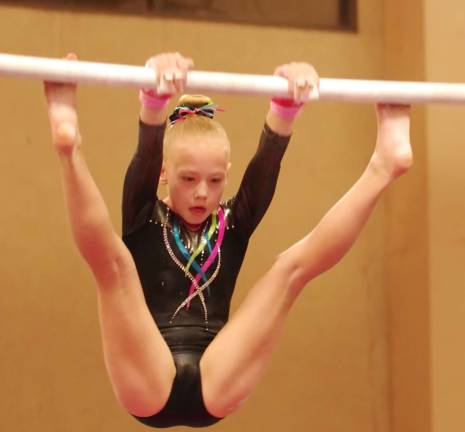 Westys Gymnastics (Franklin Borough, N.J.) athlete HAILEY JENKINS (7) performes on the uneven bars. Jenkins placed first on uneven bars with an 8.9 and floor routine with an 8.3 in her division as well as Second Place All Around with a 31.85.