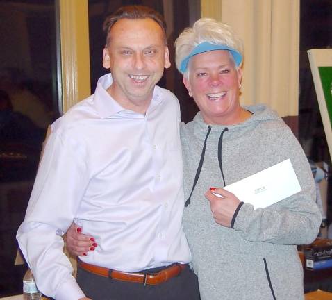 Karin Law receives her closest to the pin prize from Crystal Springs VP of Golf Operations Art Walton