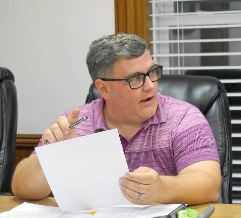 Ogdensburg Council President Michael Nardini reviews a spreadsheet for the DPW