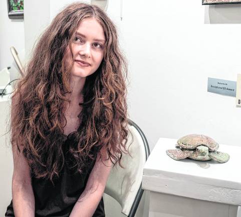 <b>Annalyse Tattoli poses with her scuplutre, Gaia's Shell.</b>