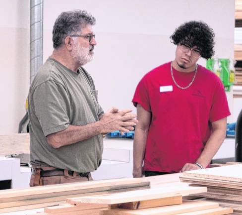 John Haboob instructs Angel Rodriguez.