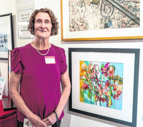 <b>Ann Smiga Greene is shown with her piece, Last Blooms of Summer.</b>