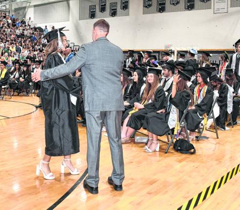 A graduate receives her diploma.