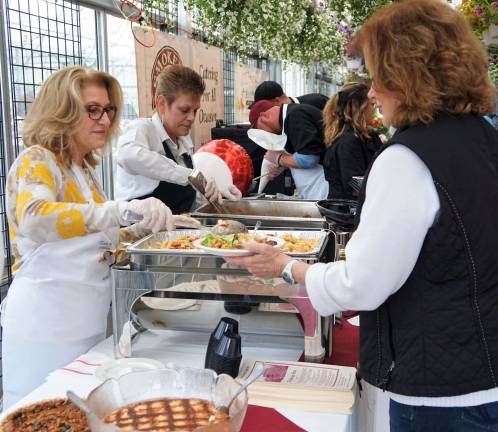 George Inn owner Litsa serves a guest.