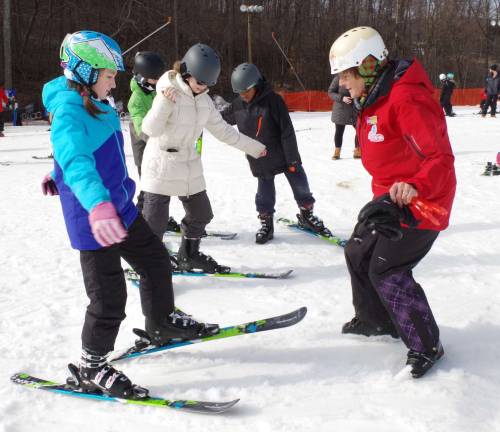 Ski instructor Stephanie Arendarski of Highland Lakes offers some very animated pointers to the visiting YMCA children.