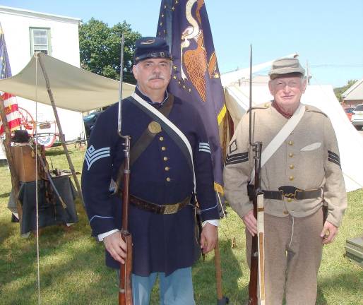 Union soldier re-enactor Jeff Chandler of the 27th NJ Regiment and Confederate soldier Ken Le Soine of the 23rd North Carolina Regiment pose with full military garb