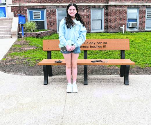 Olivia Verpent of Franklin stands by a chalk drawing.