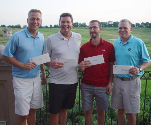 The winning team of Kevin Reed, Kevin Orabone, Mike Rafanello and Craig Gorczyca bask in the light of a beautiful sunset