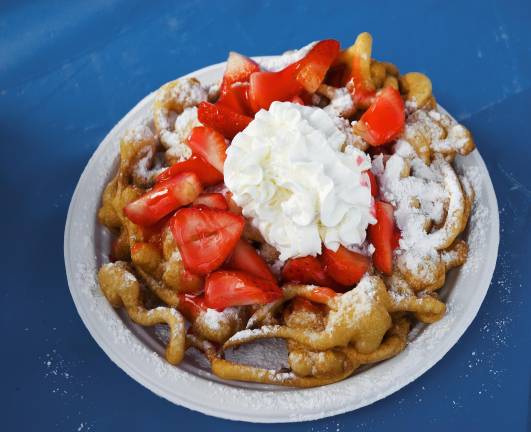 <b>Multiple vendors will be serving up classic funnel cakes at the fair this year.</b>