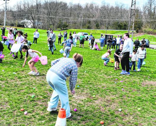 Children pick up Easter eggs.