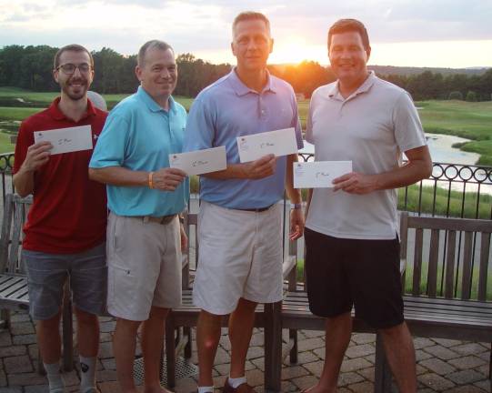 The winning team of Kevin Reed, Kevin Orabone, Mike Rafanello and Craig Gorczyca bask in the light of a beautiful sunset