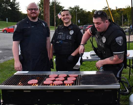 Officer Brendan Prol,Sgt. Robert Vander and Officer Nick Della Fera work the grill.