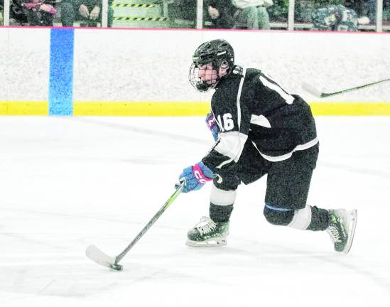 K.J.S. United's Eddie Brown steers the puck. Brown made 2 assists.