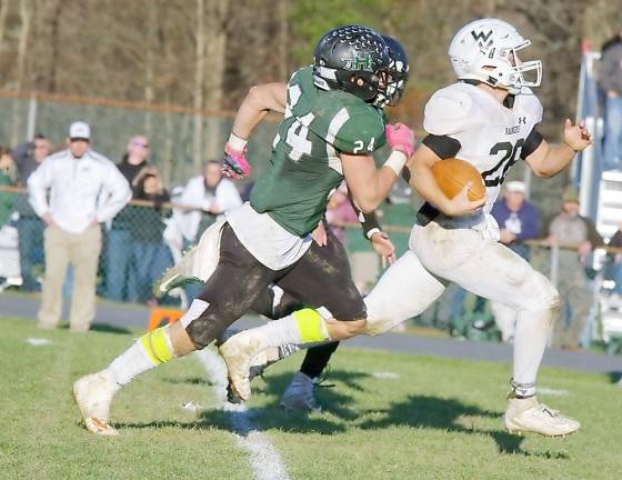 Wallkill Valley ball carrier Ben Mizeski is grabbed by a Hopatcong defender in the second half. Mizeski rushed for 244 yards and scored three touchdowns.
