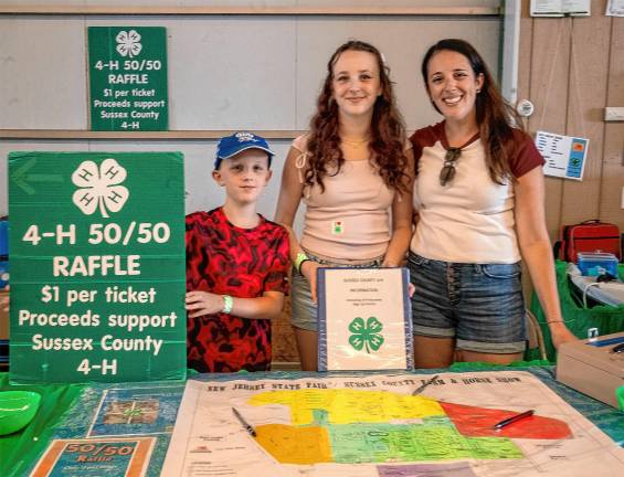 <b>4-H members Joanne, Adina and Eli Nieman sell raffle tickets Saturday, Aug. 2. (Photo by Nancy Madacsi)</b>