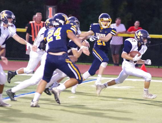 Jefferson ball carrier Matthew Cappello blasts through a hole in the Vernon defense in the first half. Jefferson Township High School (Oak Ridge, N.J.) defeated Vernon Township High School in varsity football on Friday, September 15, 2017. The final score was 16-6. Vernon Township High School in Glenwood, N.J.) hosted the game.