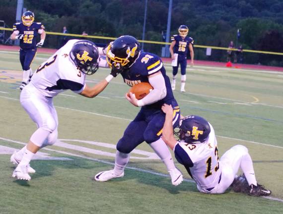 Vernon's ball carrier Mike Stefkovich tussles with Jefferson defenders Andrew Benfatti and Paul Monaco (13). Stefkovich rushed for one touchdown. Jefferson Township High School (Oak Ridge, N.J.) defeated Vernon Township High School in varsity football on Friday, September 15, 2017. The final score was 16-6. Vernon Township High School in Glenwood, N.J.) hosted the game.