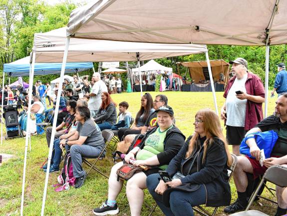 Festival attendees watch the sword-fighting.
