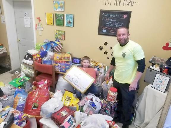 Hunter Schmick at the Vernon Animal Shelter with the supplies he collected for homeless pets (Photo provided)
