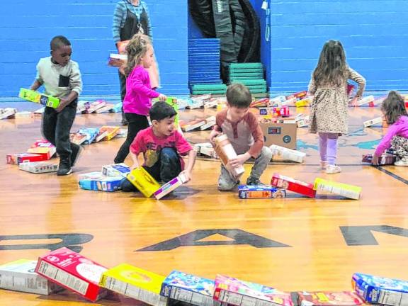 Students help pack up the cereal boxes to be taken to local food pantries.