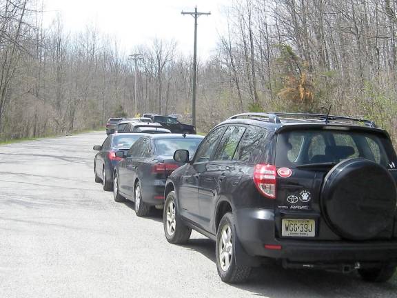 Cars line the access road leading to the Wawayanda State Park parking lot.