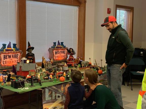 Visitors to the Sussex-Wantage library branch look at the club’s Halloween display of model trains in October. (Photo provided)
