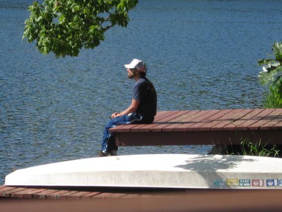 PHOTO BY JANET REDYKEA dock owner reflects on a breezy Friday afternoon.