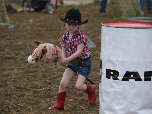 Amelia Murphy (4) of Wantage makes her way along an obstacle course. Murphy won the best dressed cowgirl contest for the second year in a row.