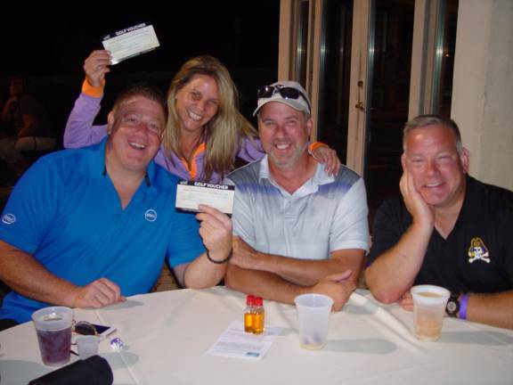 Closest to the Pin &amp; Women’s Long Drive winner Mark Galluccio &amp; Lisa Malnichuk celebrate their win with friends
