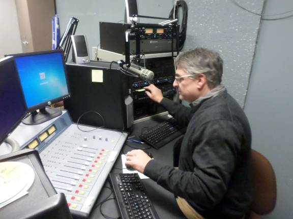 Anthony Selimo, founder of the Sussex County Community College radio program, sits at the control board of the college's 1620 AM station and future 97.5 Fm station. Photo by Nathan Mayberg